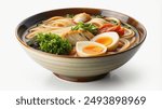 A close-up view of a bowl of ramen noodles with egg, chicken, and vegetables.