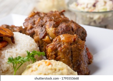 A Closeup View Of Braised Oxtail Cuts, Part Of A Plated Entree, In A Restaurant Or Kitchen Setting.
