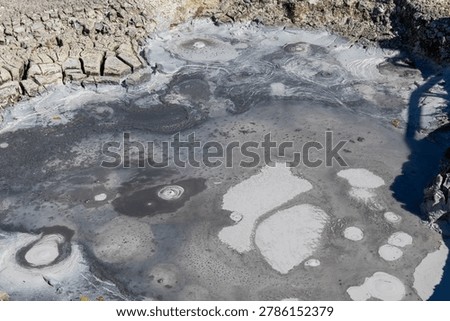 Close-up view of bubbling mud volcano pots and mineral clay pools in the Uzon Caldera geothermal field, Kamchatka Krai, Russia, natural volcanic landscape