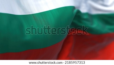 Close-up view of the Bulgarian national flag waving in the wind. Bulgaria is a country in Southeast Europe. Fabric textured background. Selective focus