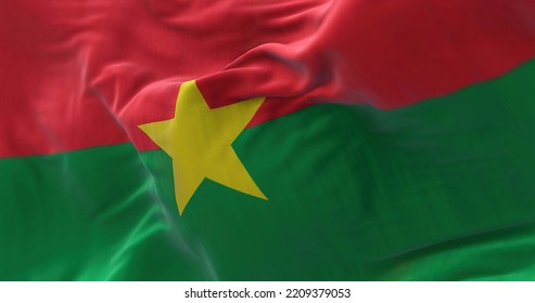 Close-up View Of The Burkina Faso National Flag Waving In The Wind. Burkina Faso Is A Country In West Africa. Fabric Textured Background. Selective Focus