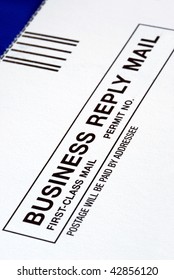 Close-up View Of A Business Reply Mail Isolated On Blue