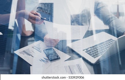 Closeup view of business team working together in coworking place.Concept young people making new startup project.Double exposure,skyscraper office building blurred background - Shutterstock ID 533929306