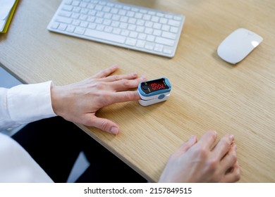 Closeup View Of A Business Woman Measuring Blood Oxygen Levels Using A Pulse Oximeter