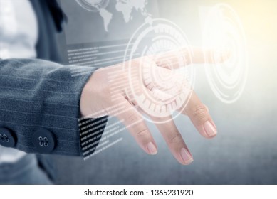 Closeup view of business woman touch a circle on virtual screen which display the interface of world map and binary code. Digital technology concept