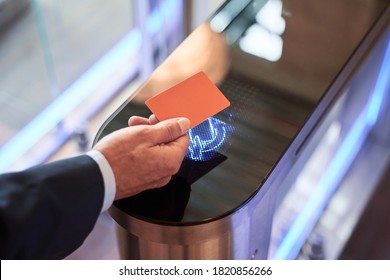 Close-up view of businessman scanning his card at turnstile gate