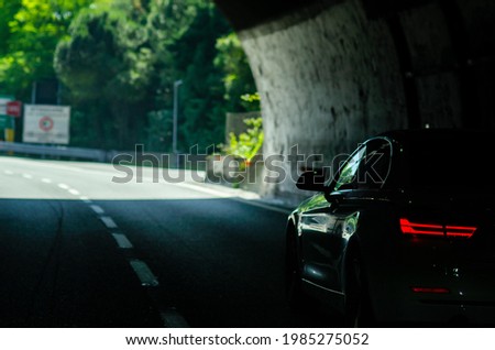 Close-up view of the car leaves the road tunnel on Italian highway