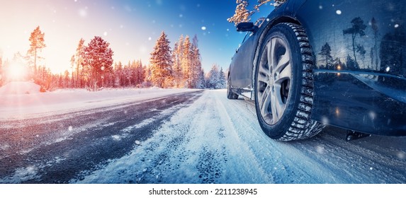 Closeup view of the car's wheel on the snowy road in natural park - Powered by Shutterstock