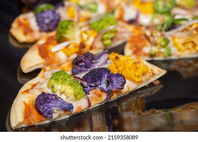 A Closeup View Of A Cauliflower Flatbread.