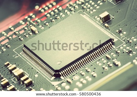 Closeup view of a central processing unit or CPU on electronic board. CPU is electronic circuit within a computer that caries out the instructions of a computer program by performing basic arithmetic.