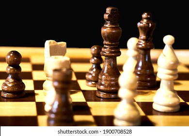 Close-up view of a chess game, with selective focus on the black king.
