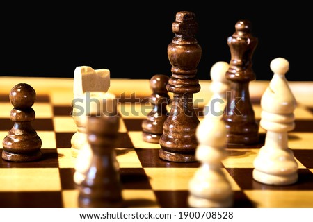 Close-up view of a chess game, with selective focus on the black king.