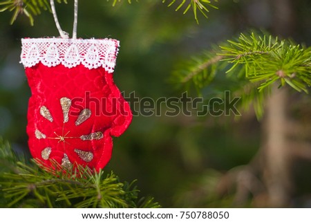 Closeup view of christmas decoration. Xmas mockup with red mitten and fir-tree