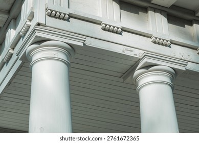 A close-up view of a clock on the side of a building, with details visible.