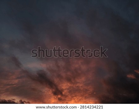 A close-up view of the cloud cover during sunset, where gray, pink, and golden hues intertwine. The image is ideal for scientific research in climatology, weather forecasting, aviation themes, and as an immersive graphic background