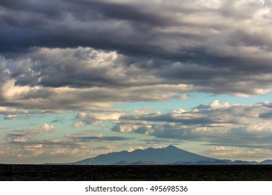 Closeup view of cloudy sky and remote mountains 