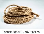 Closeup view of coiled ropes string isolated over a white background