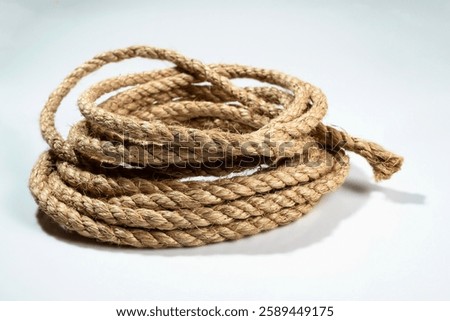 Closeup view of coiled ropes string isolated over a white background