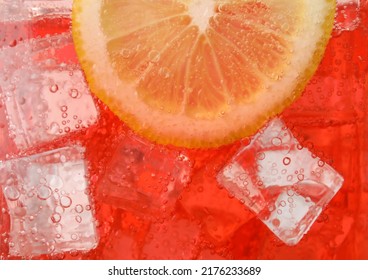 Closeup view of cold refreshing drink with ice and lemon slice in glass