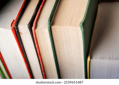 A close-up view of colorful books lined up on a shelf in a cozy study environment - Powered by Shutterstock