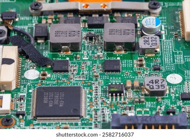 A close-up view of a computer circuit board featuring a central processing unit (CPU) surrounded by various electronic components and intricate wiring.