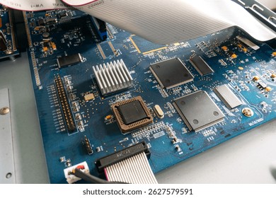 A close-up view of a computer motherboard showcasing intricate components and connections essential for digital processing and functionality in electronic systems.