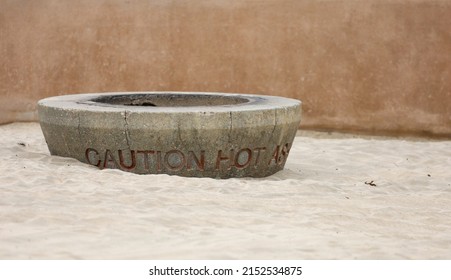 Close-up View Of A Concrete Fire Pit On The Sand At The Beach.