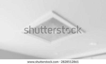 A close-up view of a contemporary square ceiling light fixture, showcasing its minimalist design against a plain white backdrop.
