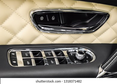 Closeup view of controls on the car door. Car interior detail.