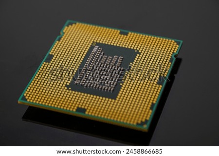 Close-up view of a CPU (Central Processing Unit) with visible pins and intricate architecture. Computing chip on an old motherboard. Old electronics close-up. Electronic background