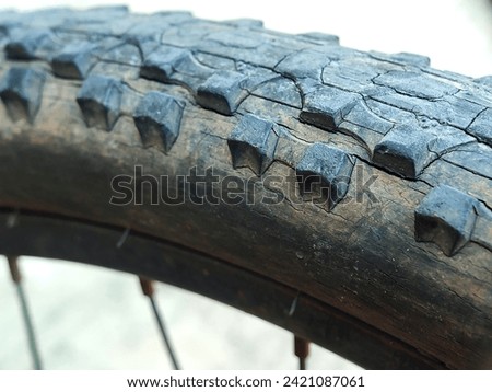 Close-up view of cracked and dirty bicycle tire surface texture
