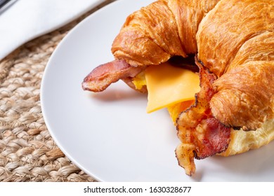 A Closeup View Of A Croissant Breakfast Sandwich.