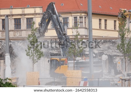 Close-up view of crumbling bridge structure demolition in Magdeburg Damaschkeplatz  exposed steel rebar falling concrete chunks. Rubble piles and demolition machinery emphasize destruction progress