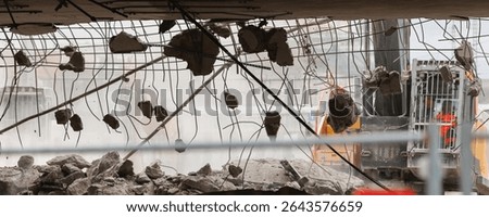 Close-up view of crumbling bridge structure demolition in Magdeburg Damaschkeplatz  exposed steel rebar falling concrete chunks. Rubble piles and demolition machinery emphasize destruction progress