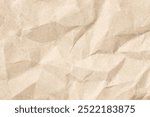 Close-up view of a crumpled brown paper texture, ideal for various design projects, backgrounds, or crafts needing an organic and textured feel.