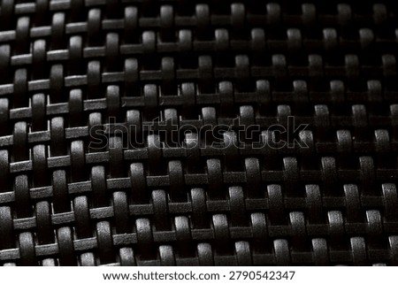 Close-up view of dark elegant wickerwork surface texture for design background.