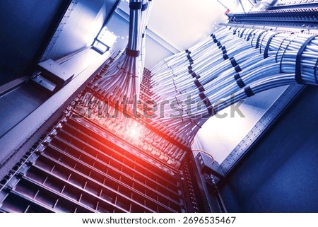 A close-up view of a data center showcasing neatly organized cables and server racks. This image highlights technology and infrastructure in a modern environment.