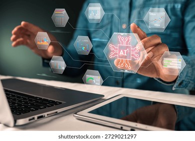A close-up view of a data scientist working at a modern office desk with a laptop and tablet computer. The professional is reaching out to touch a futuristic holographic interface displaying a central microchip icon with the glowing text "AI". Surrounding the central processor are floating hexagonal screens featuring various types of data visualization, including colorful bar charts, line graphs, pie charts, and statistical diagrams. This image perfectly illustrates the concept of Big Data Analytics and Business Intelligence (BI), where Artificial Intelligence algorithms help interpret complex information. The visual metaphor highlights the role of technology in financial forecasting, market research, and strategic planning. The glowing digital overlay against the dark background emphasizes the advanced nature of the software, symbolizing the future of data processing, machine learning, and automated reporting systems used by analysts and corporate decision-makers to drive growth and efficiency.