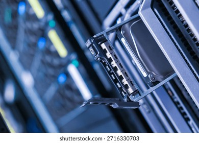 Close-up view of a data storage device inserted into a server rack. The technology showcases modern equipment used for efficient data management in network systems.