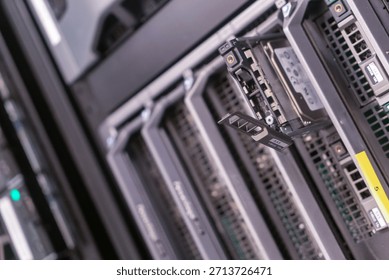 Close-up view of a data storage server featuring an open hard drive tray, showcasing modern technology and infrastructure in a server room setting.