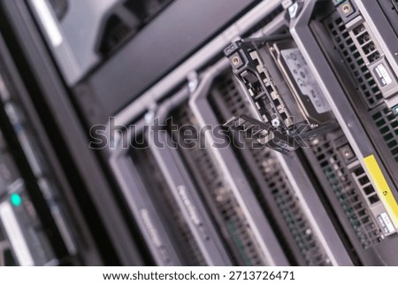 Close-up view of a data storage server featuring an open hard drive tray, showcasing modern technology and infrastructure in a server room setting.