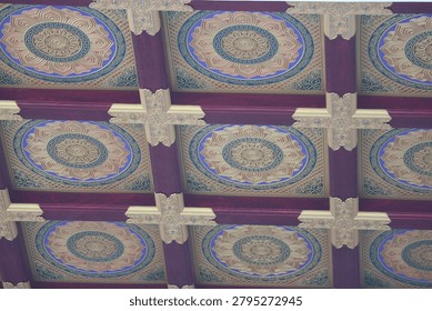 A close-up view of a decorative ceiling featuring intricate mosaic patterns