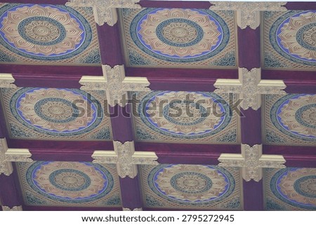 A close-up view of a decorative ceiling featuring intricate mosaic patterns