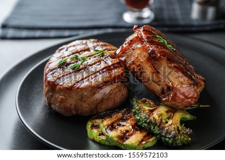 Closeup view of delicious grilled beef medallions served on table