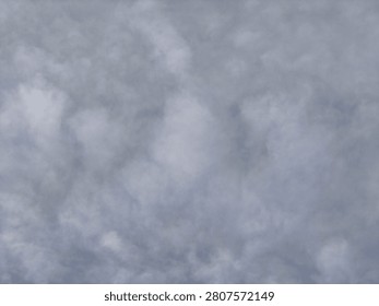 A close-up view of densely packed grey and white clouds, creating a textured and atmospheric background filling the entire