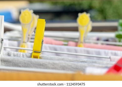 Closeup view of different clothes hanging on the clotheshorse for drying