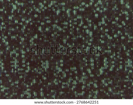 A close-up view of a digital screen matrix with a dark background and glowing pixel elements