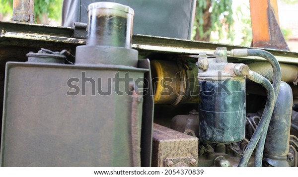 Close-up view of\
dirty oil filter. Old excavator engine black metal oil filter with\
copy space. selective\
focus