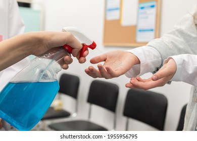 Close-up view of disinfecting hands of patients entering a clinic, performed by medical staff in the face of a pandemic - Powered by Shutterstock