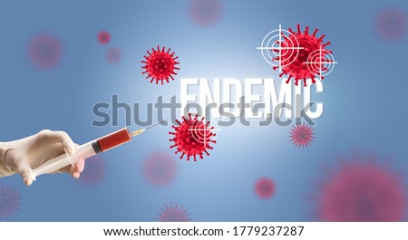 Close-up view of doctor's hand in a white glove holding syringe with ENDEMIC inscription, coronavirus antidote concept